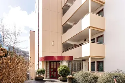 a white building with a red door at City apartment with balcony and 3 bedrooms! in Bergen