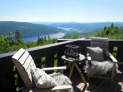 two chairs and a table on a deck with a view at Large Cabin For 20 By Norefjell Ski Resort in Noresund