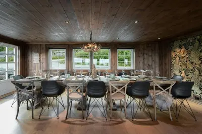 a dining room with a large table and chairs at Large Cabin For 20 By Norefjell Ski Resort in Noresund