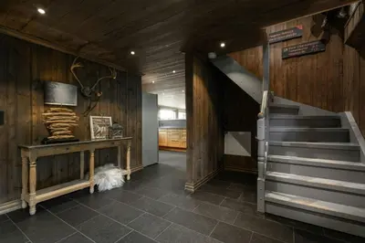 a hallway with a staircase in a room with wooden walls at Large Cabin For 20 By Norefjell Ski Resort in Noresund