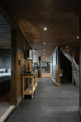 a hallway of a house with a bed and a table at Large Cabin For 20 By Norefjell Ski Resort in Noresund