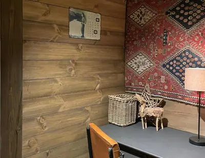 a room with wooden walls and a table with a lamp at Fjellhytte Med Panorama På Toppen Av Norefjell in Noresund