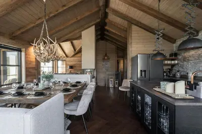 a kitchen with a large wooden table and a dining room at Designer Cabin For 16 With Spa In Turufjell in Flå