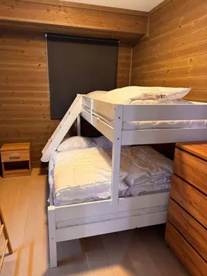 a bunk bed in a room with wooden walls at Kikut1010 Skurdalsvegen 107 in Hol