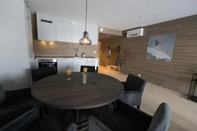 a dining room with a wooden table and chairs at Kikut1010 Skurdalsvegen 107 in Hol