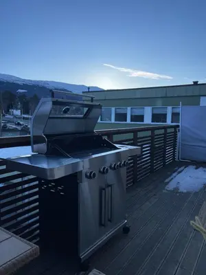 a barbecue grill on a deck on a roof at Modern apartment - Balcony, Parking, BBQ in Vossevangen