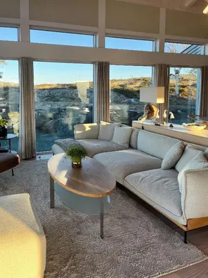 a living room with a couch and a table at Cottage With Sunny Terraces And Sea Views in Lysøysund