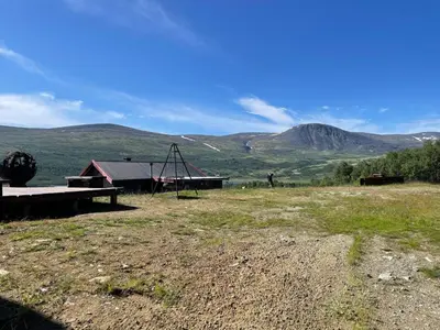 a playground in a field with mountains in the background at Live in the realm of the musk oxen on Dovrefjell in Hjerkinn