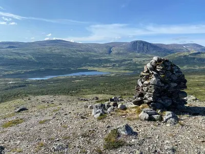 a pile of rocks on top of a mountain at Live in the realm of the musk oxen on Dovrefjell in Hjerkinn