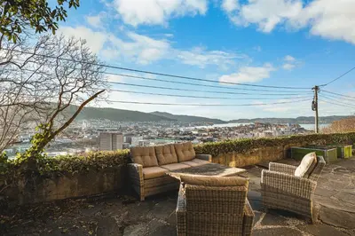a couch and chairs sitting on a ledge with a view at A Dream Home with Spectacular Views - NEW! in Bergen