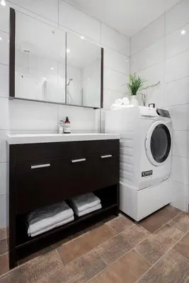 a bathroom with a washing machine and a sink at Spacious 2-room in the city center, easy access to everything in Ålesund