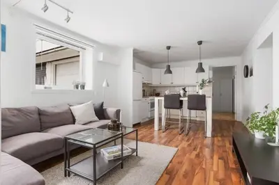 a living room with a couch and a table at Central 4 room apartment in Bergen