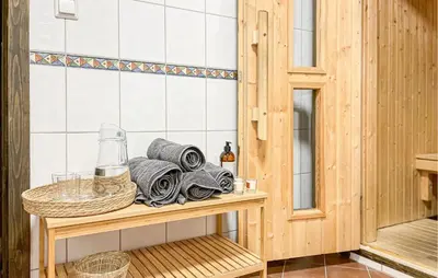 a bathroom with a shelf with towels and a mirror at Lovely Home In Sjusjøen With Sauna in Sjusjøen