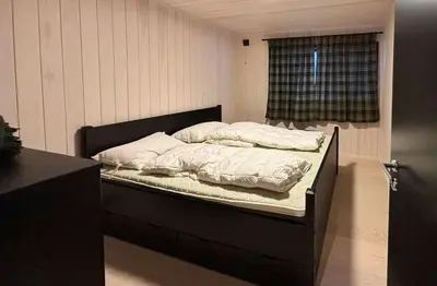 a bed with two pillows on it in a room at Architect Cabin With Ski-In Near Trysil in Trysil