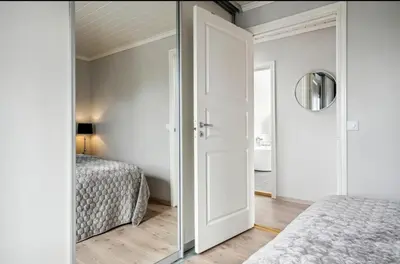 a bedroom with a mirror and two beds at Spacious house with a beautiful view for rent in Ålesund