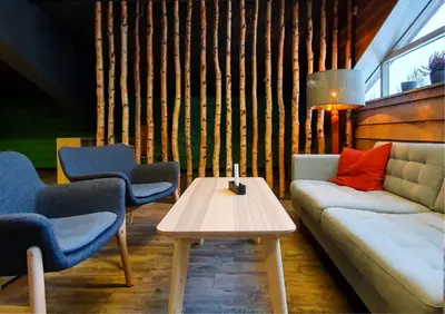 a living room with a couch and two chairs and a table at Kvikne Fjellhotell & Kafé in Tynset