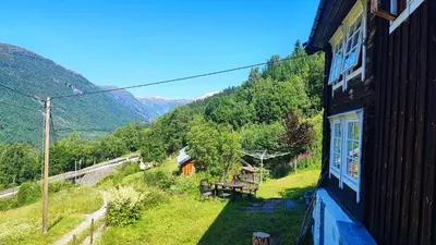 a house with a view of a mountain at The old farm Lodge Lykkeslet