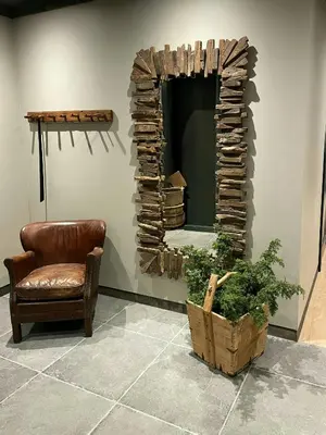 a living room with a chair and a fireplace at Modern Farm With Panoramic Views And Nature in Bjorli