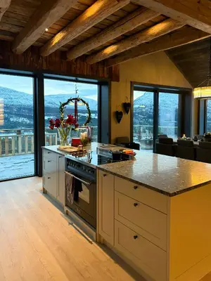 a kitchen with a counter with a stove top oven at Modern Farm With Panoramic Views And Nature in Bjorli