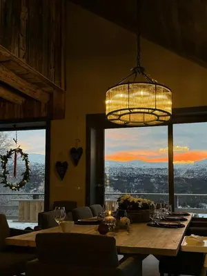 a dining room with a table and a chandelier at Modern Farm With Panoramic Views And Nature in Bjorli