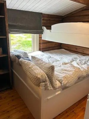 a bed in a room with a window at Log Cabin With 360-Degree Views Near Trysil in Trysil