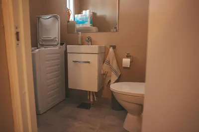 a small bathroom with a sink and a toilet at Solyun in Hol