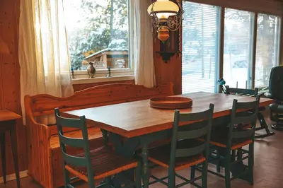 a wooden table and chairs in a room with a window at Solyun in Hol