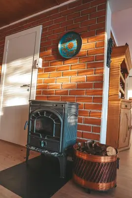 a brick wall with a stove in a room at Solyun in Hol