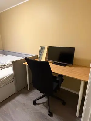 a desk with a computer and a chair in a room at Modern apartment in Raufoss in Raufoss