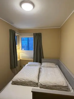 a bedroom with two beds and a window at Modern apartment in Raufoss in Raufoss