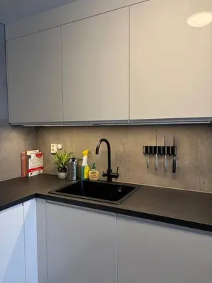a kitchen with white cabinets and a sink at Modern apartment in Raufoss in Raufoss