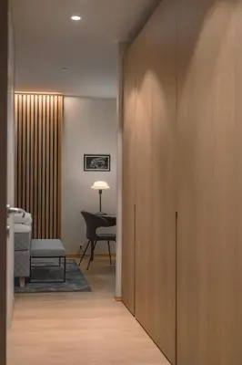 a hallway with a door leading to a room with a desk at Bellevue Penthouse - Exclusive Design in Bergen