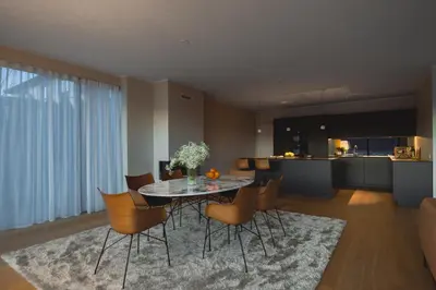 a dining room and kitchen with a table and chairs at Bellevue Penthouse - Exclusive Design in Bergen