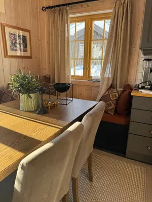 a dining room with a table and a window at Cozy ski in & out cabin Hemsedal in Hemsedal