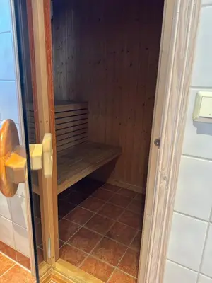 a shower with a wooden bench in a bathroom at Cozy ski in & out cabin Hemsedal in Hemsedal