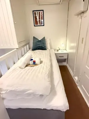 a bedroom with a white bed with a tray on it at Pellan in Surnadal