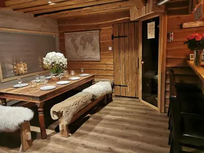 a wooden dining room with a table and chairs at Cozy family cottage with a view
