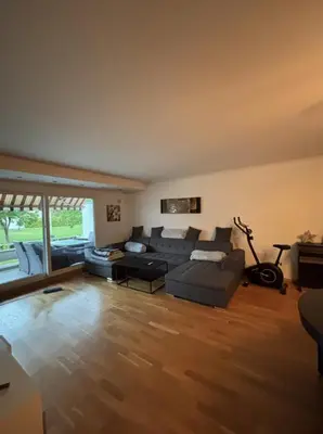 a living room with a couch and a table at Etterstad in Lii