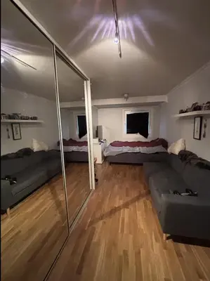 a living room with two beds and a couch at Etterstad in Lii