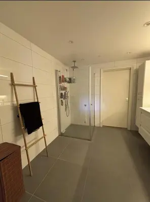 a bathroom with a shower and a glass door at Etterstad in Lii