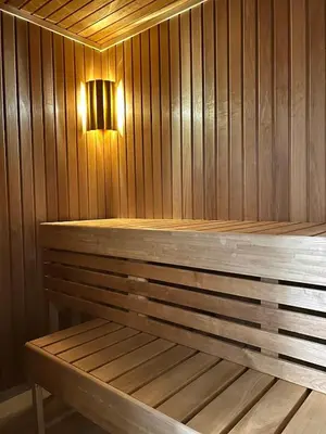 a wooden bench in a sauna with a light at High standard, large cabin with amazing view in Stryn