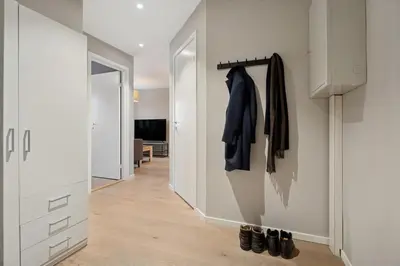 a room with a hallway with a closet and a coat rack at Apartment with garage in the center of Lillehammer in Lillehammer