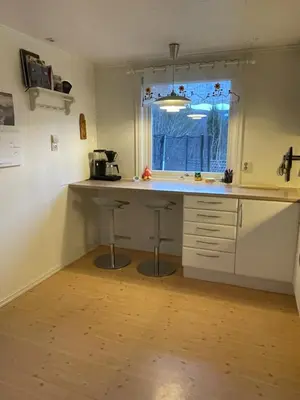 a kitchen with a counter and a window at Bolig på Kaupanger in Kaupanger