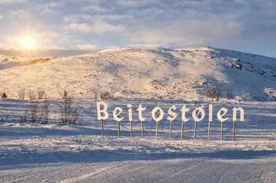 a sign in the snow in front of a mountain at Modern family cabin with ski in out, central location in Beitostølen in Beitostøl