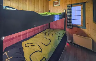 a room with two bunk beds and a window at Beautiful Home In Lampeland With Sauna in Lampeland