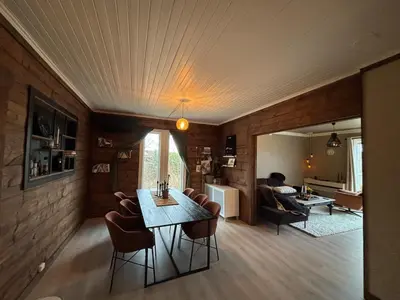 a living room with a table and chairs at Charming newly renovated house in city centre in Verdal