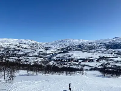 a person is skiing down a snow covered slope at New! Stay close to Hardangervidda & Vøringsfossen in Eidfjord