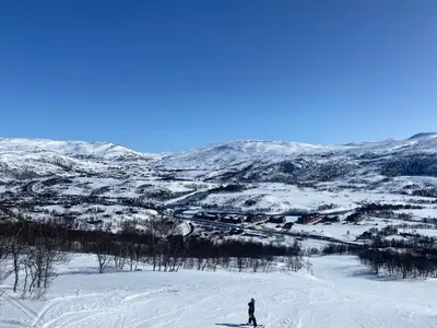 a person is skiing down a snow covered slope at New! Stay close to Hardangervidda & Vøringsfossen in Eidfjord