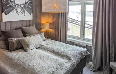 a bedroom with a bed with a large window at 2 Bedroom Lovely Apartment In Rjukan in Rjukan