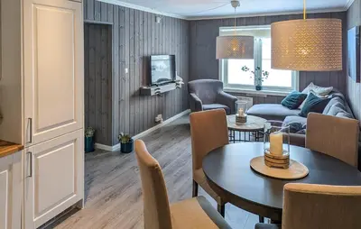 a living room with a table and a couch at 2 Bedroom Lovely Apartment In Rjukan in Rjukan